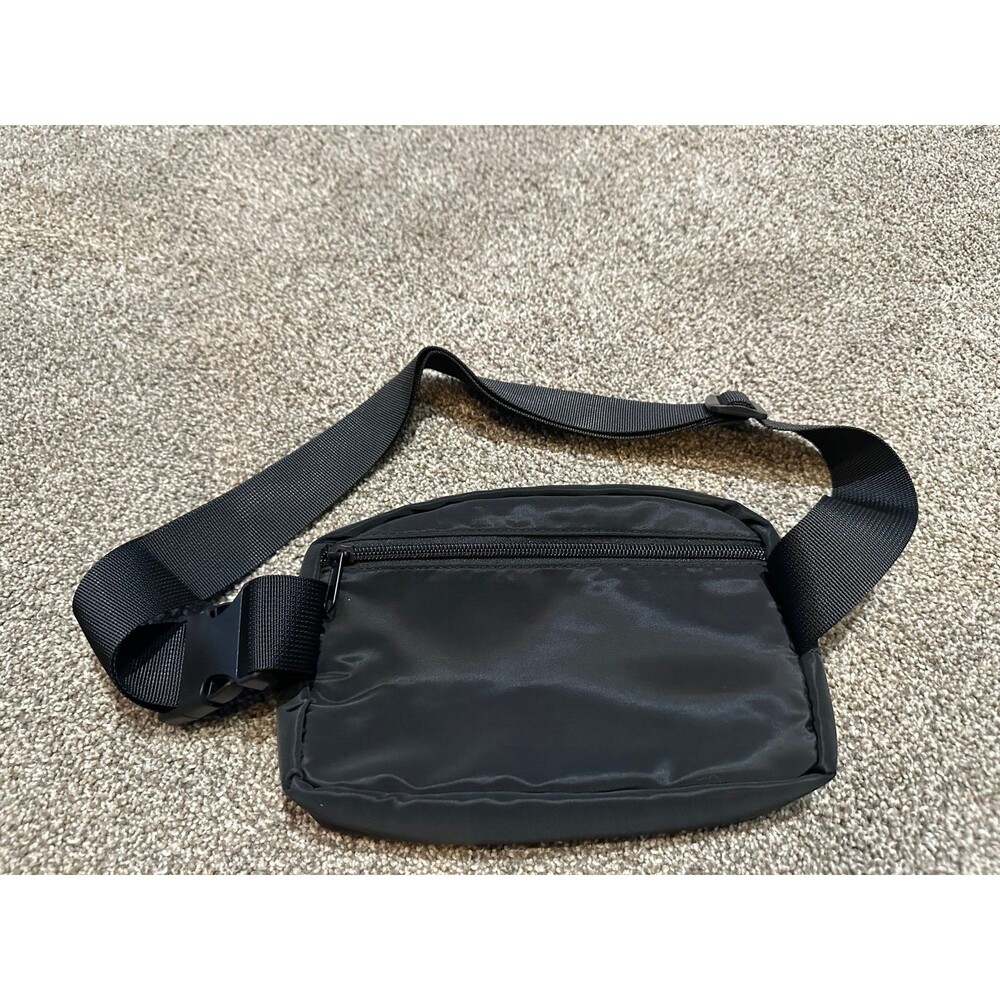 Black belt bag with gold zipper